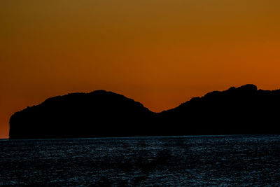 Scenic view of sea against romantic sky at sunset