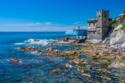 Scenic view of sea against buildings