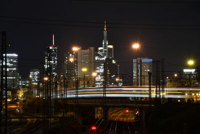 Illuminated city against sky at night