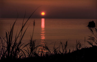 Scenic view of sea against romantic sky at sunset