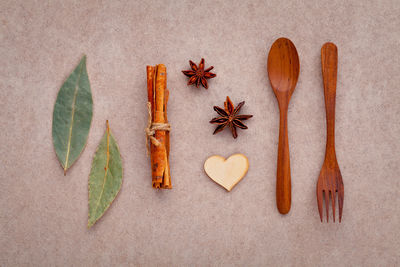 Close-up of spices with wooden spoon and fork