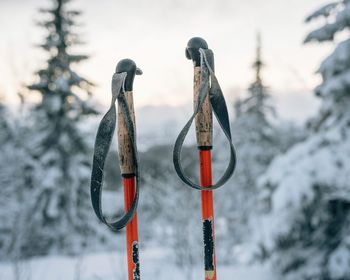 Close-up of ski poles hanging  against sky