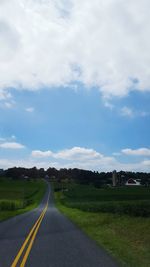 Road by landscape against sky