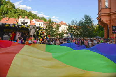 Crowd in park against sky in city