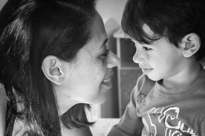 Close-up of happy mother with son at home