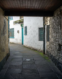 Empty alley amidst buildings