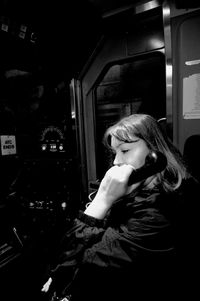 Portrait of woman looking through window