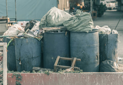 Stack of garbage bin against built structure