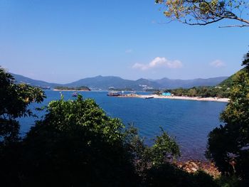 Scenic view of bay against blue sky