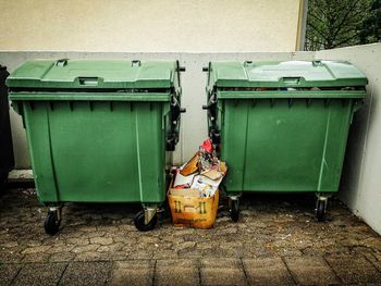 Garbage cans against wall