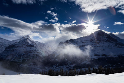 Scenic view of snowcapped mountains against sky