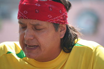 Close-up of man wearing red bandana