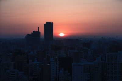 Modern buildings against romantic sky at sunset