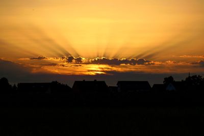 Silhouette landscape against sky during sunset