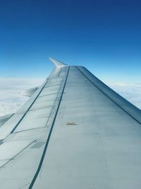 Airplane wing against sky