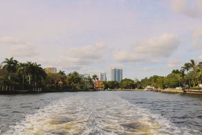 Scenic view of sea by buildings against sky