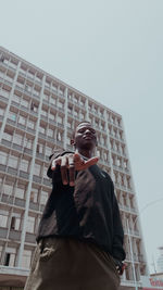 Low angle view of man standing against clear sky