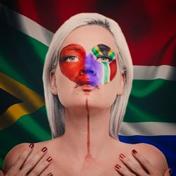 Close-up of young woman with south african flag face paint