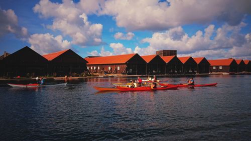 People in boat against sky