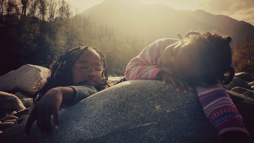 Close-up of friends relaxing outdoors