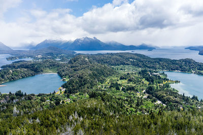 Scenic view of sea and mountains against sky