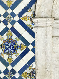 Close-up of tiled floor against building