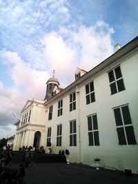 Buildings against cloudy sky