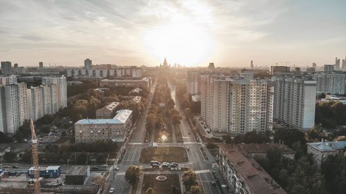 High angle view of city buildings against sky during sunset