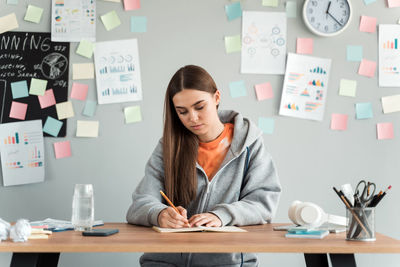 Young woman sitting on table