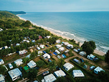 High angle view of tent townscape by sea against sky