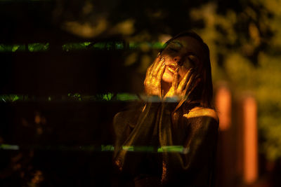 Close-up of young woman with golden skin in the reflection