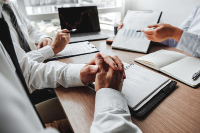 Midsection of business colleagues working in office