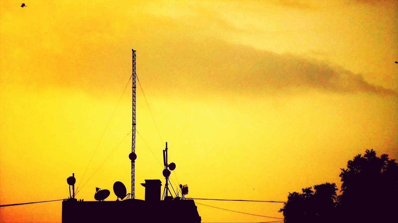 sunset, silhouette, architecture, orange color, built structure, building exterior, low angle view, sky, communications tower, street light, power line, spire, yellow, communication, copy space, outdoors, lighting equipment, high section, tower, travel destinations
