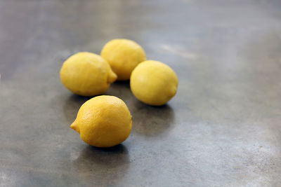 Close-up of lemons on wooden table