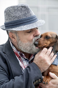 Mature man kissing dog