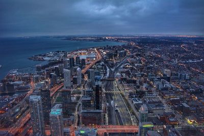 High angle view of city lit up at night