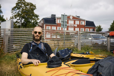 Man sitting in kayak and looking at camera