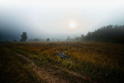 Scenic view of field against sky during foggy weather