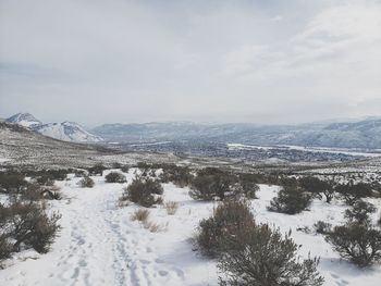 Scenic view of snowcapped mountains against sky