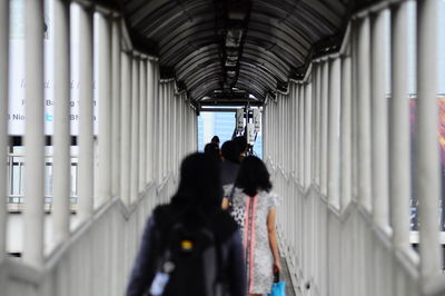 Rear view of people walking in corridor