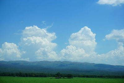 Scenic view of landscape against blue sky