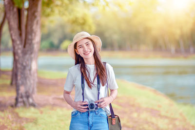 Portrait of a smiling young woman standing outdoors