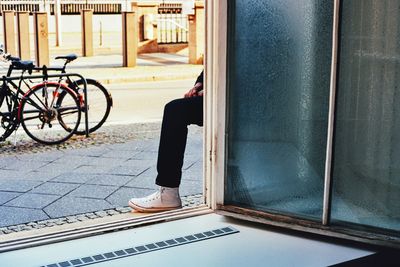 Man leg on doorway by sidewalk 