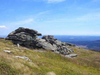 Scenic view of rocks on landscape against sky