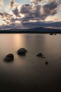 Scenic view of lake against cloudy sky