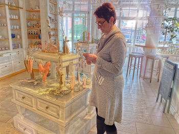 Woman looking at camera while standing on table