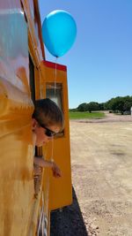 Boy with balloon at window in miniature train