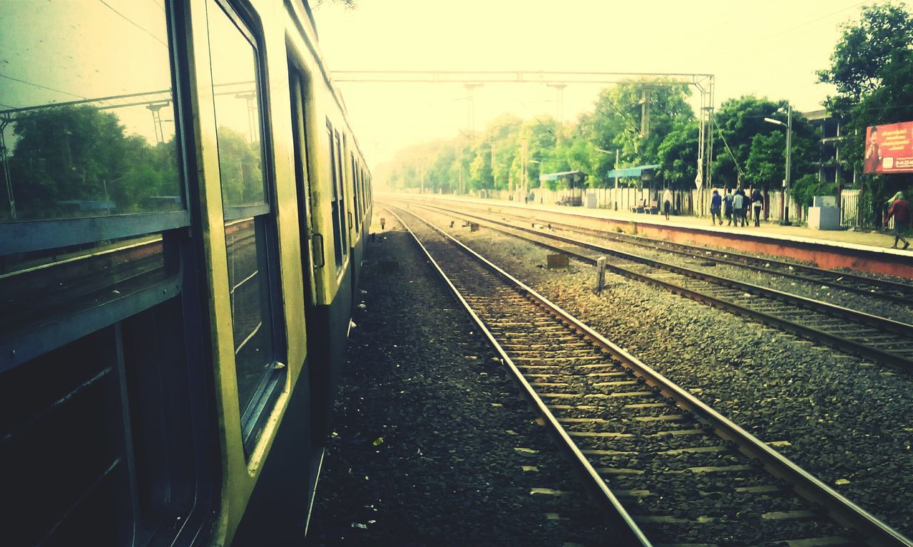 railroad track, transportation, rail transportation, public transportation, train - vehicle, mode of transport, railroad station platform, railway track, railroad station, train, travel, passenger train, tree, diminishing perspective, the way forward, vanishing point, public transport, journey, sky, day