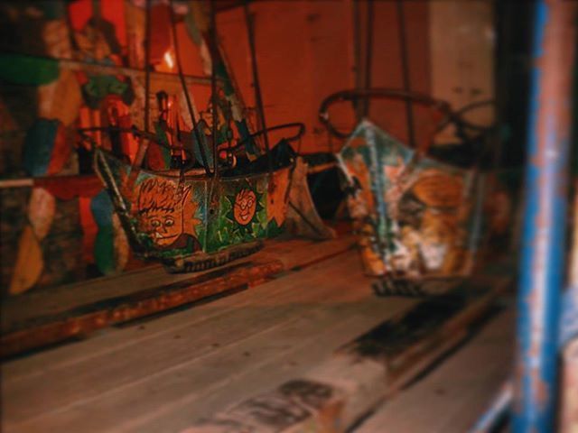 indoors, wall - building feature, hanging, selective focus, art and craft, metal, close-up, no people, focus on foreground, art, built structure, graffiti, illuminated, creativity, architecture, multi colored, wood - material, old, wall, day