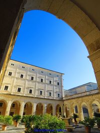 Low angle view of historical building against blue sky